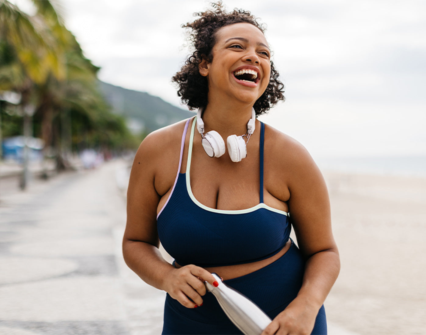 Woman in athletic wear smiling outdoors